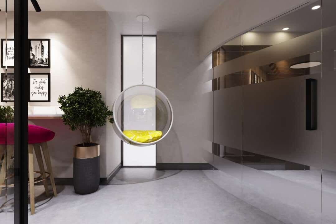 Lounge corner with a hanging bubble chair and potted plant